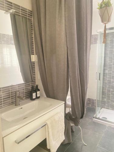 a bathroom with a tub and a sink and a window at MAISON REBECCA in Carpi