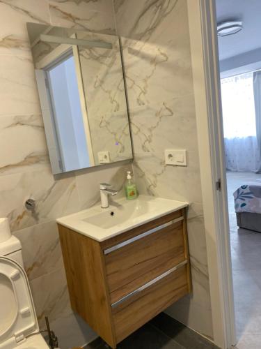 a bathroom with a sink and a mirror at Del Mar three bed flat. in Puerto de Sagunto