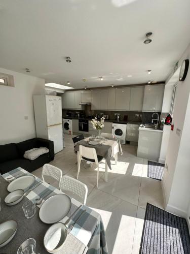 a kitchen and living room with a table and chairs at Double and single rooms in Bromley by bow in London