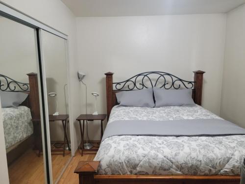 a bedroom with a bed and a mirror at RJN in Fairbanks