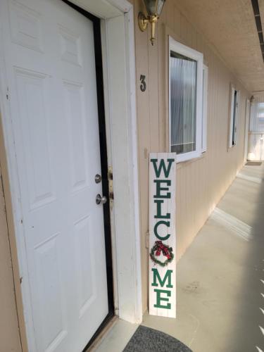 a front door of a house with a welcome sign at RJN in Fairbanks