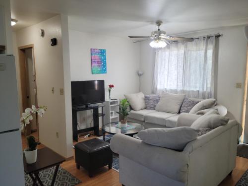 a living room with a couch and a tv at RJN in Fairbanks