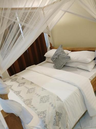 a bedroom with two beds with a canopy at ULTRA HOME-Private House in Arusha