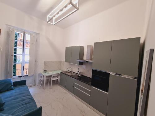 a kitchen with a large refrigerator and a table at Allegra Viareggio Appartamento & Affittacamere Guest house in Viareggio
