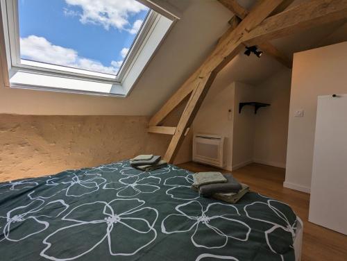 a bedroom with a bed and a large window at Celon Nous - La Porcherie in Célon