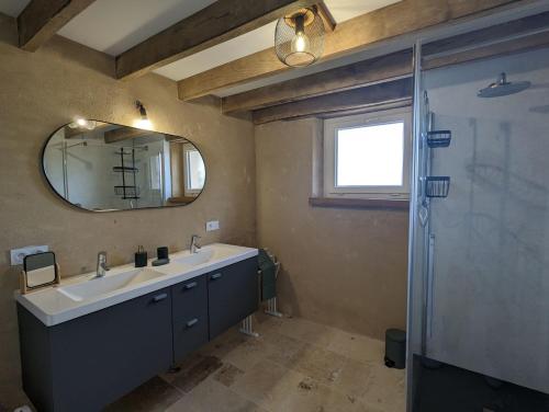 a bathroom with a sink and a mirror at Celon Nous - La Porcherie in Célon