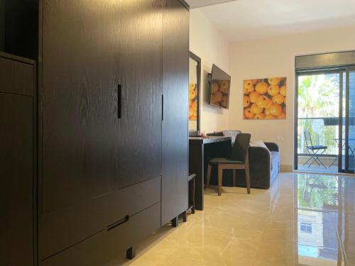 a living room with a large cabinet and a table at Mizirawi Historic Hotel in Ramallah