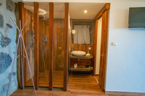 a bathroom with a walk in shower and a sink at Casa dos Lagos - RRAL nº 2187 in Velas