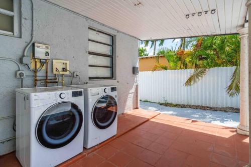 a laundry room with a washer and dryer on a patio at Miami Luxury Home! Next to Miami airport and beach in Miami