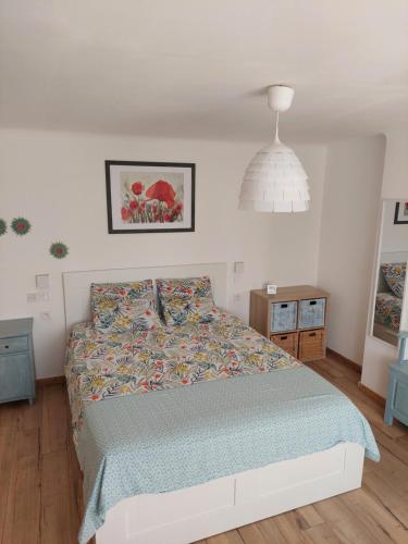 a bedroom with a bed and a pendant light at Les hirondelles in Laquenexy