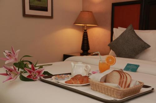 a tray of breakfast food on a bed at Boudl Salmiya, Kuwait - بودل السالمية الكويت in Kuwait