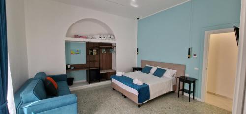 ナポリにあるLa Dimora di Parthenopeのベッドルーム(ベッド1台、青いソファ付)
