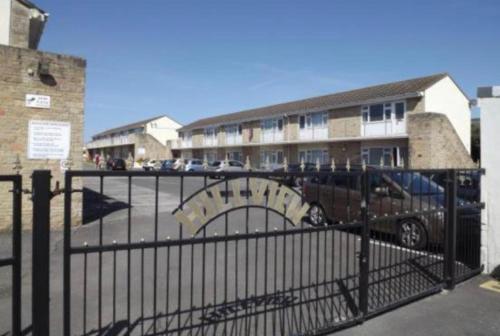 a gate with a car parked in front of a building at Ground floor apartment Brean in Brean
