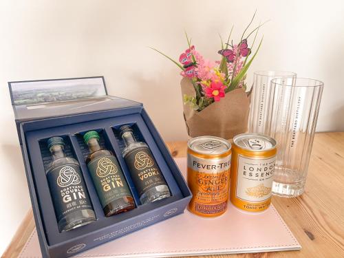 a box of beer and two cans on a table at Spacious, central and newly decorated apartment in Edinburgh