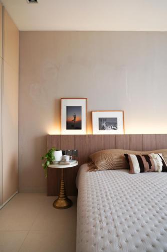 a bedroom with a bed and a small table at Velea@Rose Apple Square in Siem Reap