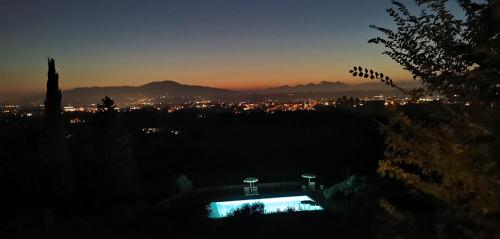 a view of a city at night with a pool at Agriturismo Cascina Cipressa in San Romano