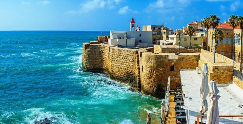 a view of the ocean and a stone wall at Suite In White in ‘Akko