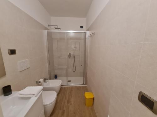 a bathroom with a shower and a toilet and a sink at Monti Guest House Alghero in Alghero