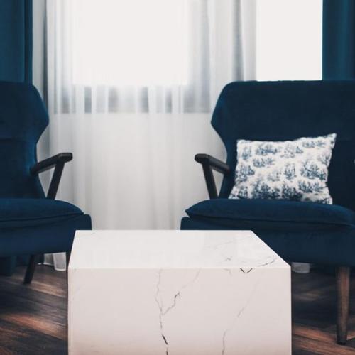 a living room with two chairs and a coffee table at BLUE LUXURY SUITES in Preveza