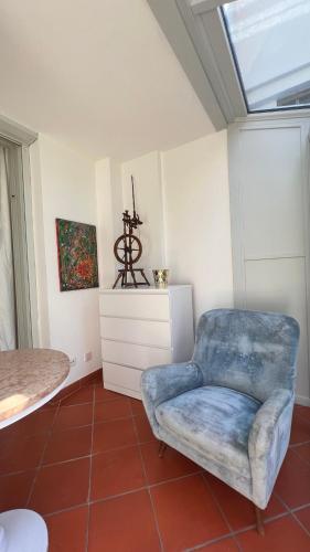 a room with a blue chair and a table at Garden Suite in Bolzano
