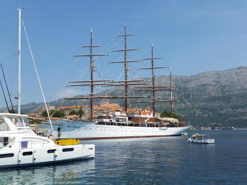 a large ship is docked in the water at Castello Rezidence Korcula in Korčula