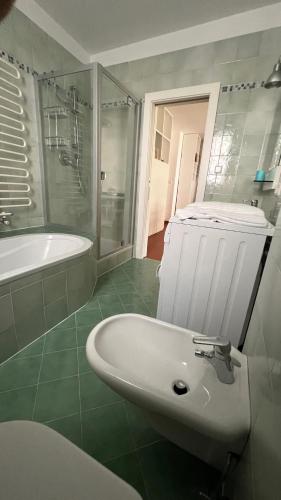 a bathroom with a sink and a tub and a toilet at Garden Suite in Bolzano