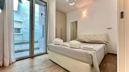 a bedroom with a bed and a large window at LuxurySmart in Misano Adriatico