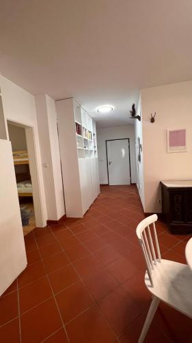 a hallway with a table and a chair in a room at Garden Suite in Bolzano