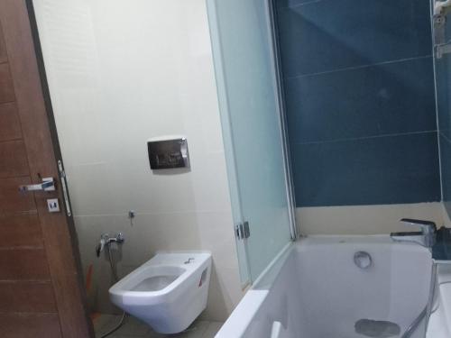 a bathroom with a toilet and a tub and a sink at Appart de Luxe au Centre Urbain Nord in Tunis