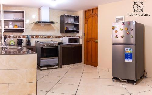 a kitchen with a stainless steel refrigerator and appliances at SSAMANA MARÍA APARTMENT 202 in Arequipa
