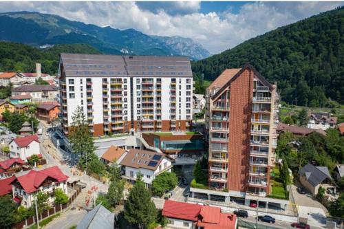 an aerial view of a city with buildings and mountains at JACUZZI BELLE VIEW SINAIA in Sinaia