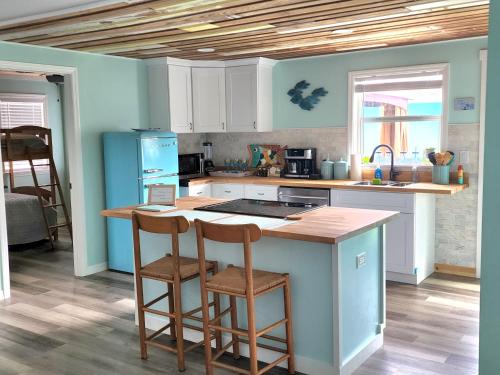 a kitchen with a counter and two chairs at a island at The Guest House in Largo