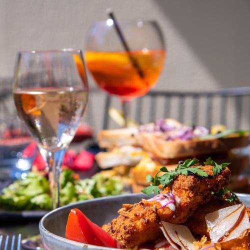 a table with a plate of food and a glass of wine at ibis Aix en Provence in Aix-en-Provence