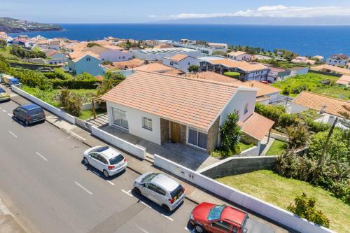 a house with cars parked in a parking lot at Blue Planet São Jorge Azores - RRAL nº 1341 in Velas