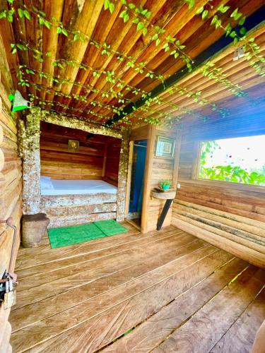 an inside view of a wooden room with a bed at Parque ecoturistico in Cali