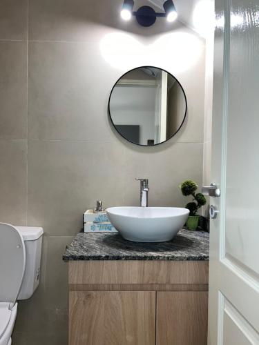 a bathroom with a white sink and a mirror at COMPLEJO VICTORIO in San Luis