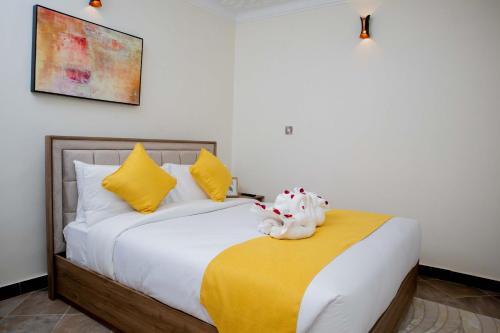 a bedroom with a bed with a stuffed animal on it at Blueberry Villas in Eldoret