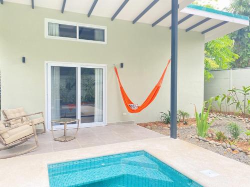 a house with a swimming pool in a yard at Villas Mar y Coral in Puerto Viejo