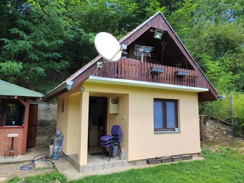 a small house with a satellite on the roof at Mala Vikendica in Kruševac