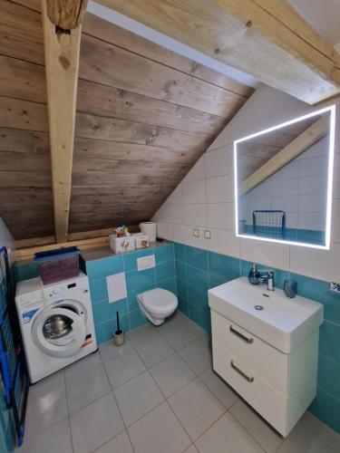 a bathroom with a washing machine and a washer at Apartmán U kostela in Semily
