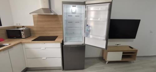 a refrigerator in a kitchen with white cabinets at Situación inmejorable. Céntrico y tranquilo in Carrizal