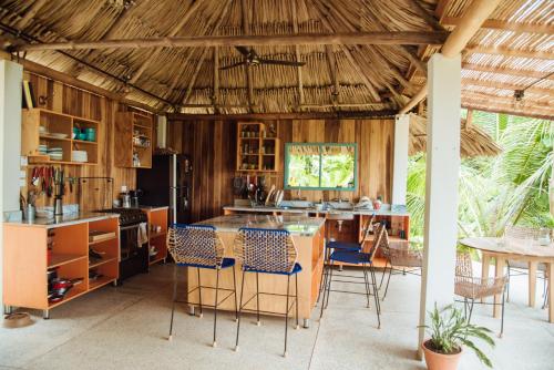 a kitchen with a table and chairs in a room at The Fort Hostel in Don Diego