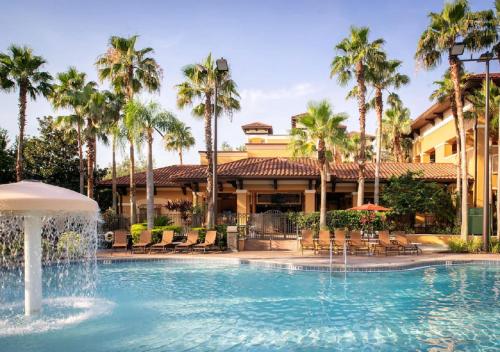 a pool with a fountain in front of a hotel at Cozy Orlando Resort Condo 4Mi from Disney in Orlando