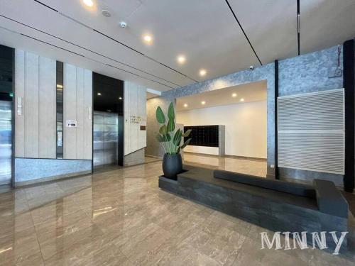 a lobby with a fireplace and a potted plant at Netizen walk to MRT 4-5pax in Cheras