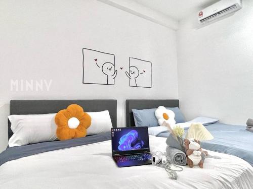 a bedroom with a bed with a laptop on it at Netizen walk to MRT 4-5pax in Cheras
