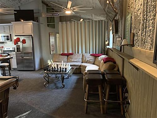 a living room with a couch and a chess board at Cozy Barn with Pool Access & Near Lake Conroe in Montgomery