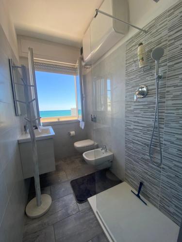 a bathroom with a shower and a sink and a toilet at ATTICO VISTA MARE in Misano Adriatico