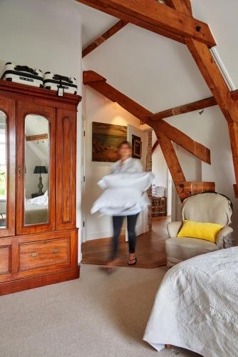 a woman is dancing in a bedroom with a dresser at Hotel Station Amstelveen in Amstelveen