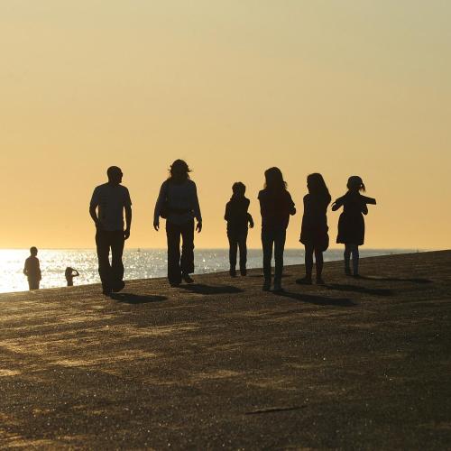 a group of people walking on the beach at Strandcamping Valkenisse in Biggekerke