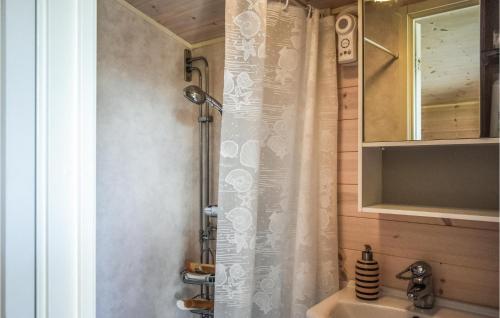 a shower curtain in a bathroom with a sink at Beautiful Home In Frjestaden With Wifi in Färjestaden